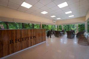 a reception area of a building with chairs and a reception desk at Summit Green Lake Tea Resort & Spa in Jakhalābāndha +40 photos