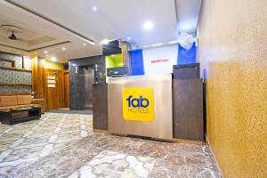 a lobby with a fico honors sign on the wall at FabHotel Royal Lagoon in Bhubaneshwar