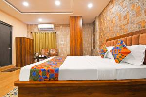 a bedroom with a large bed in a room at FabHotel Royal Lagoon in Bhubaneshwar