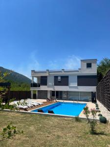 a house with a swimming pool in front of it at Vila Dar Selam halal-friendly in Mostar +6 photos