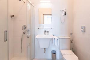 a bathroom with a toilet and a sink and a shower at Mr Görgey Art Hotel in Visegrád +47 photos