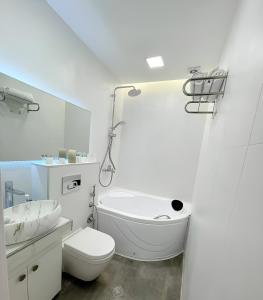 a bathroom with a tub and a toilet and a sink at winter house GUDAURI in Gudauri +73 photos