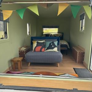 a bedroom with a bed in a room at the buttercup shed in Lochcarron