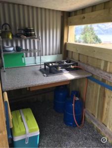 a kitchen with a stove in the inside of a trailer at the buttercup shed in Lochcarron