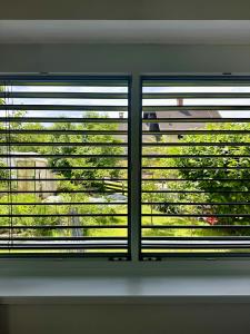 a window in a room with a view of a yard at Toni's house in Bled