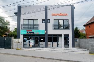 a building with a santander shop on a street at Debres Apartment Aiud in Aiud
