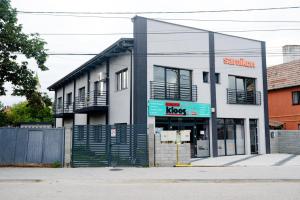 a white building with a sign that reads pawn shops at Debres Apartment Aiud in Aiud