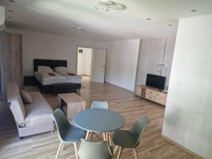 a living room with a table and chairs and a bed at Apartman EC Milica in Stapar +3 photos