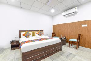 a bedroom with a bed and a table and a chair at FabHotel Connect in Jaipur