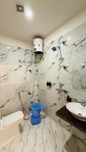 a bathroom with a toilet and a sink at Hotel Singh Palace in Varanasi