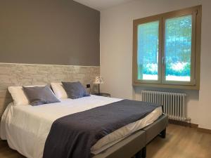 a bedroom with a large bed and a window at Casa Felicita in Ledro