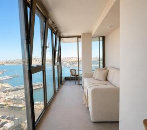 a living room with a couch and large windows at Sliema Centric Hotel in Sliema