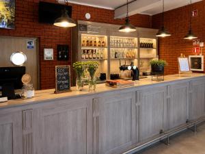 a bar in a restaurant with a counter with bottles at Karczma u Jakuba in Domaniów +12 photos