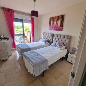 a bedroom with two beds and a window at The Gaff in the Sun in Manilva +56 photos