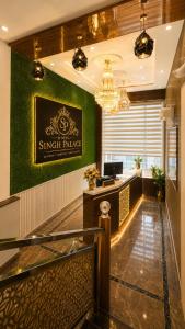 a hotel lobby with a sign on the wall at Hotel Singh Palace in Varanasi