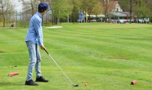 a man is playing golf in a park at Juraj apartman studio in Brdovec