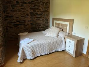 a bedroom with a bed and a brick wall at Casa Brandelos in Bama +24 photos