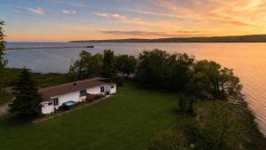 an aerial view of a house on the shore of a lake at Condo 1 - Waterfront with SPA, Fireplace & Barbecue in Sainte-Anne-de-Beaupré +31 photos