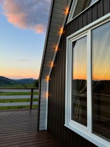 a deck with a view of the sunset from a house at lovelaz820 in Khashchovanoye