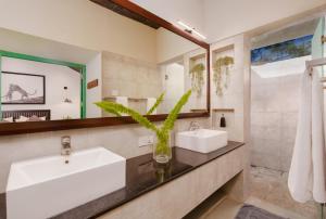 a bathroom with two sinks and a mirror at Yala Villa in Yala +31 photos