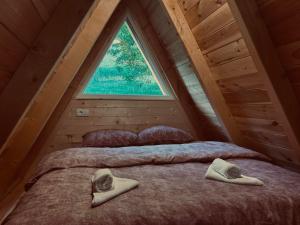 a bedroom with two beds in a attic at Ognjiste Komarnice in Komarnica