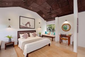 a bedroom with a large bed and a living room at Yala Villa in Yala