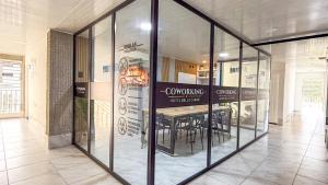 a dining room with glass walls in a building at Hotel Bello Caribe Rodadero in Santa Marta