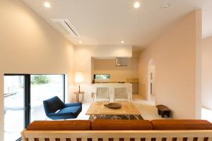 een woonkamer met een bank en een tafel bij The Canvas Hayama Park in Hayama