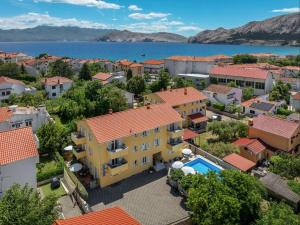 an aerial view of a town with a yellow building at Apartments Gorica 2 in Baška