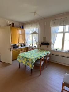 a kitchen with a table with a flowered table cloth at Örnafälla in Örnafälla