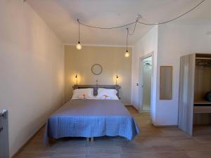 a bedroom with a large bed with a blue blanket at Agrialloggio Supramonte in Barisciano
