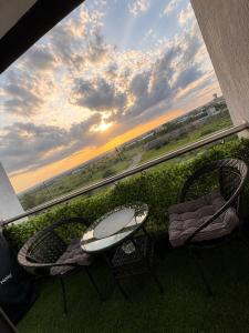 two chairs and a table on a balcony with a view at Artesano A71 in Nairobi