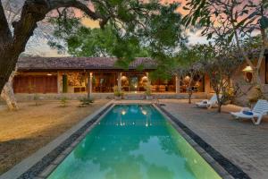 a swimming pool in front of a house at Yala Villa in Yala