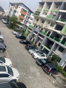 a parking lot with cars parked in front of a building at Abbey's Home in Ogoyo