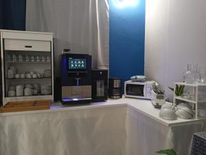 a kitchen counter with a microwave and a coffee maker at Piccolo hotel holiday center in Finale Ligure