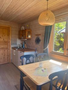 a kitchen and dining room with a table and chairs at Lystang Camping & Cabins in Notodden