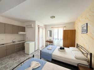 a large room with two beds and a kitchen at Villa Dima in Perissa