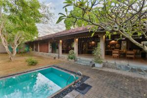 a house with a swimming pool in front of it at Yala Villa in Yala