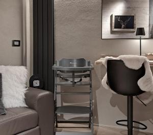 a living room with a chair and a sink at VHĀUS Apartment and Spa in Predazzo