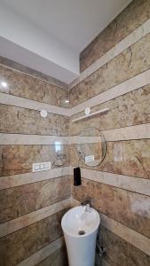 a bathroom with a sink and a mirror at Himalayan Hideaway Homestay in Kasol