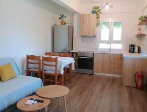a kitchen with a table and a small kitchen with a table and chairs at Etherio in Makrygialos