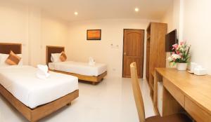 Postel nebo postele na pokoji v ubytování JS Residence Krabi