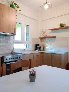 a kitchen with a white table in a room at Etherio in Makrygialos