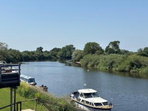 a boat is docked on a river at On the river Severn - Severnside Boat & Caravan Park, Caravan 9 in Tirley +4 photos