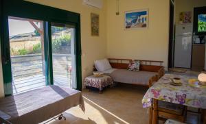 a living room with a couch and a table at Iris apartment 1 in Anaxos