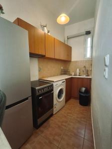 a kitchen with a washing machine and a washer at Chrysa's Studios in Loutra Edipsou +16 photos