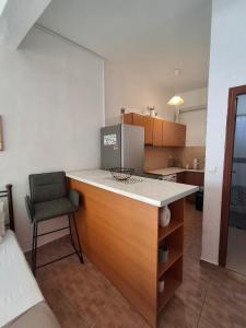 a kitchen with a counter and a chair in a room at Chrysa's Studios in Loutra Edipsou