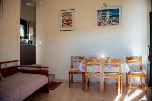 a living room with a table and two chairs at Iris apartment 1 in Anaxos