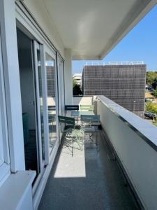 a balcony with a table and chairs on it at Chambre dans colocation à Lormont proche Bordeaux in Lormont