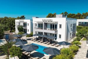 an aerial view of a hotel with a pool and umbrellas at 1oak rentals in Vir